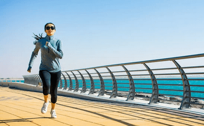 girl running on boardwalk