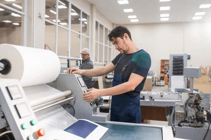 man running printing press
