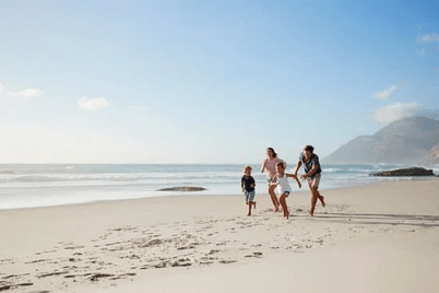 family running on beach