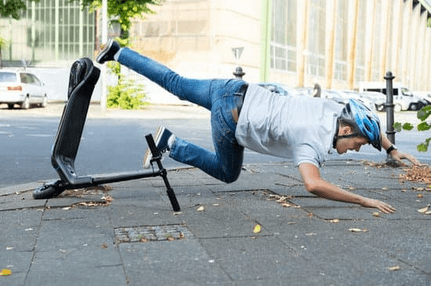 man crashing scooter