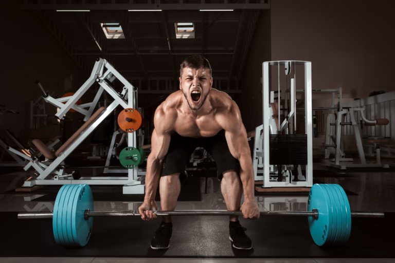 Muscle man performing a 500 lb deadlift