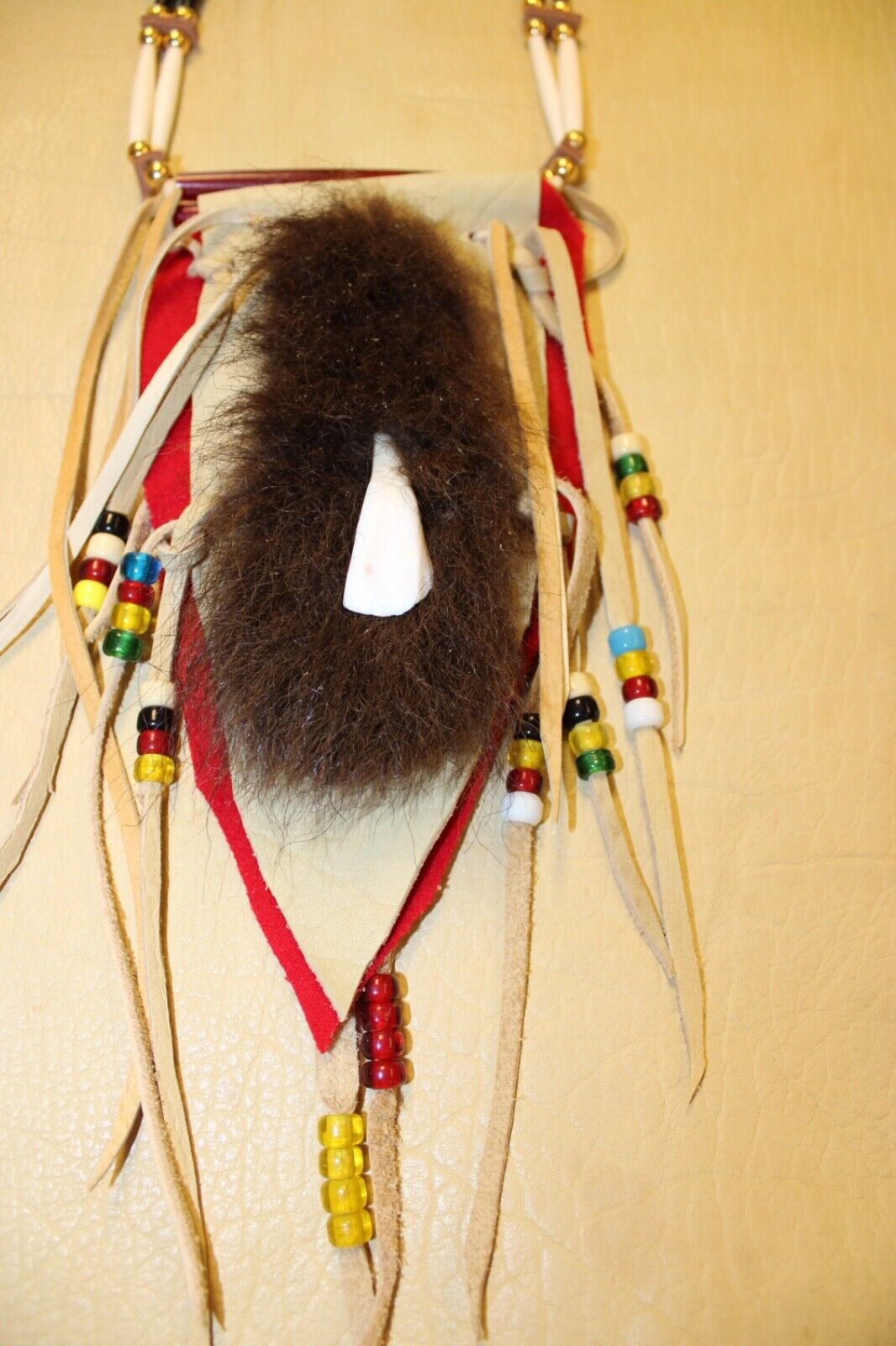 Buffalo Tooth and Hide Necklace photographed on real Buffalo hide.