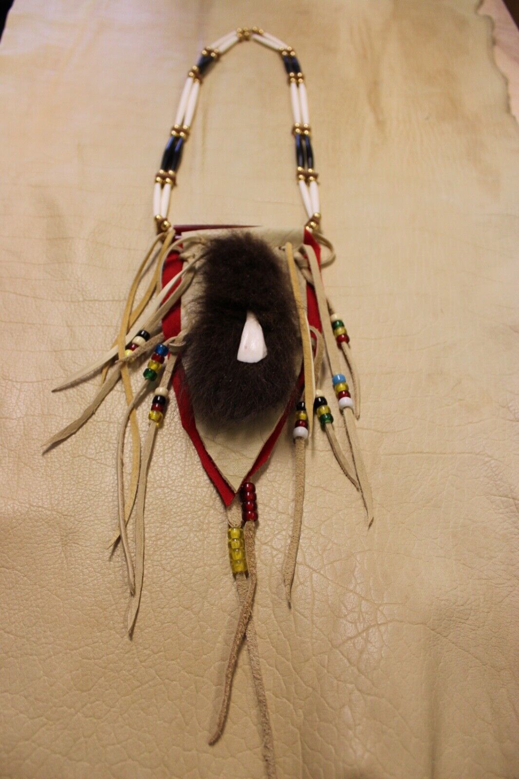 Buffalo Tooth and Hide Necklace photographed on real Buffalo hide.