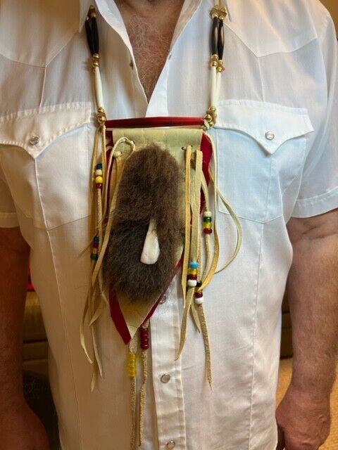 Buffalo Tooth and Hide Necklace photographed on real Buffalo hide.