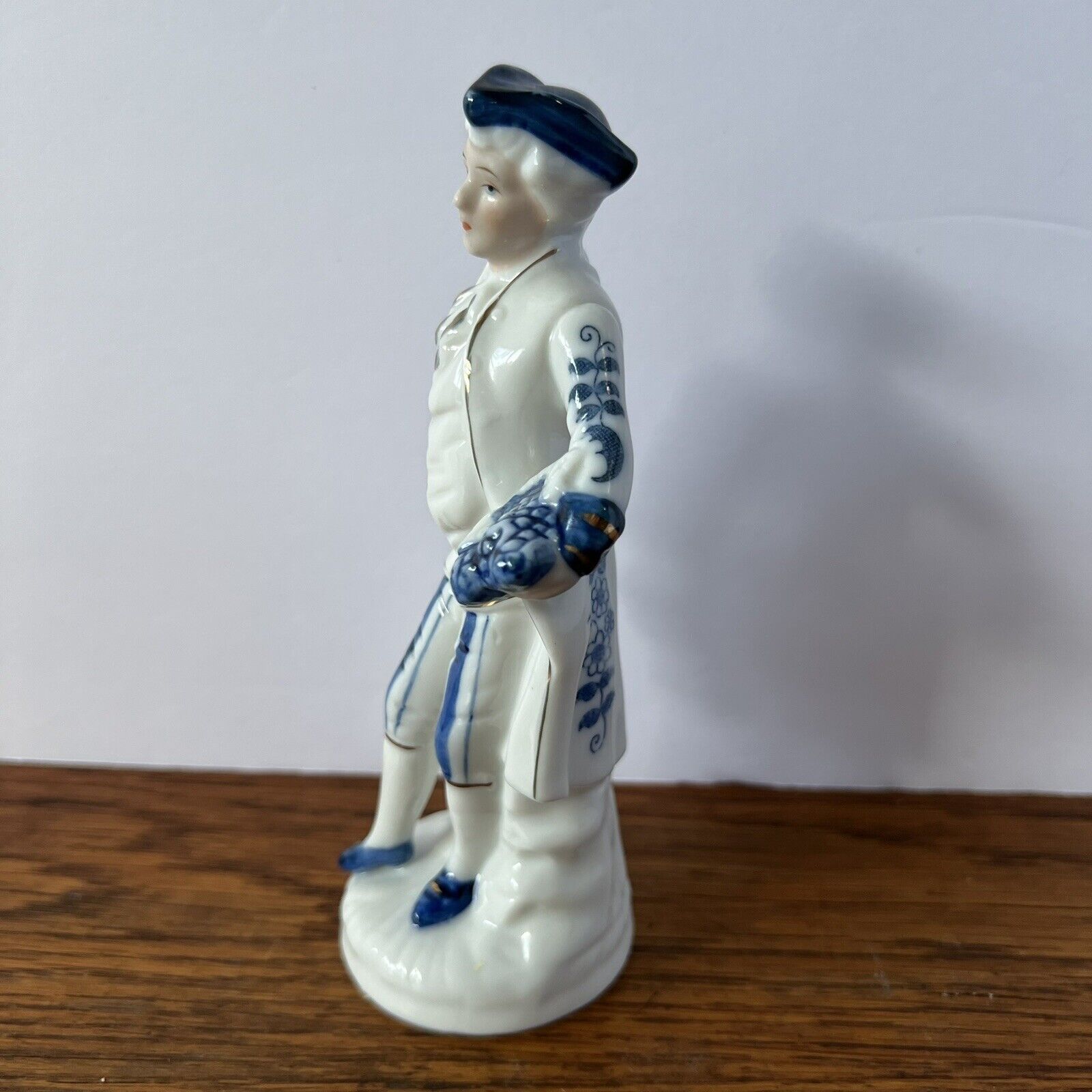 Porcelain Figure Blue and White Man with grapes, tricorne hat and 1700s garb