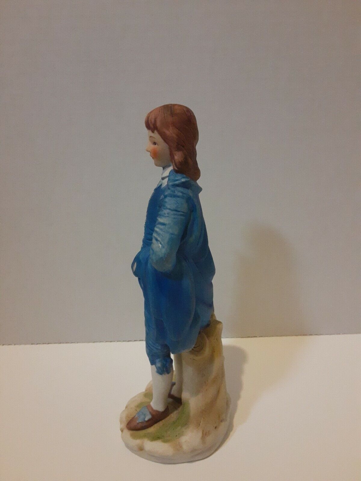 Boy In Blue Suit With Brown Hat In Hand Statue