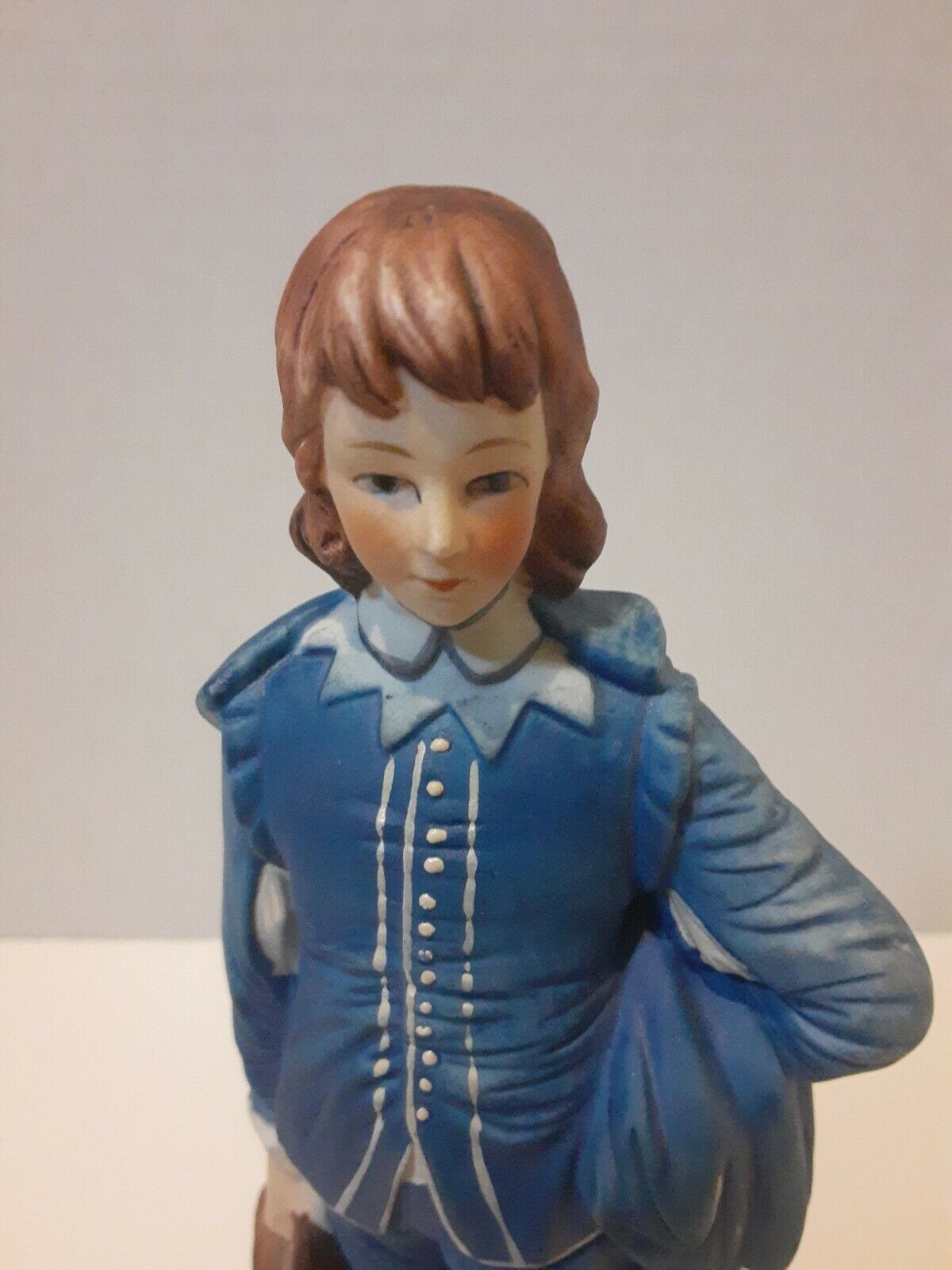 Boy In Blue Suit With Brown Hat In Hand Statue