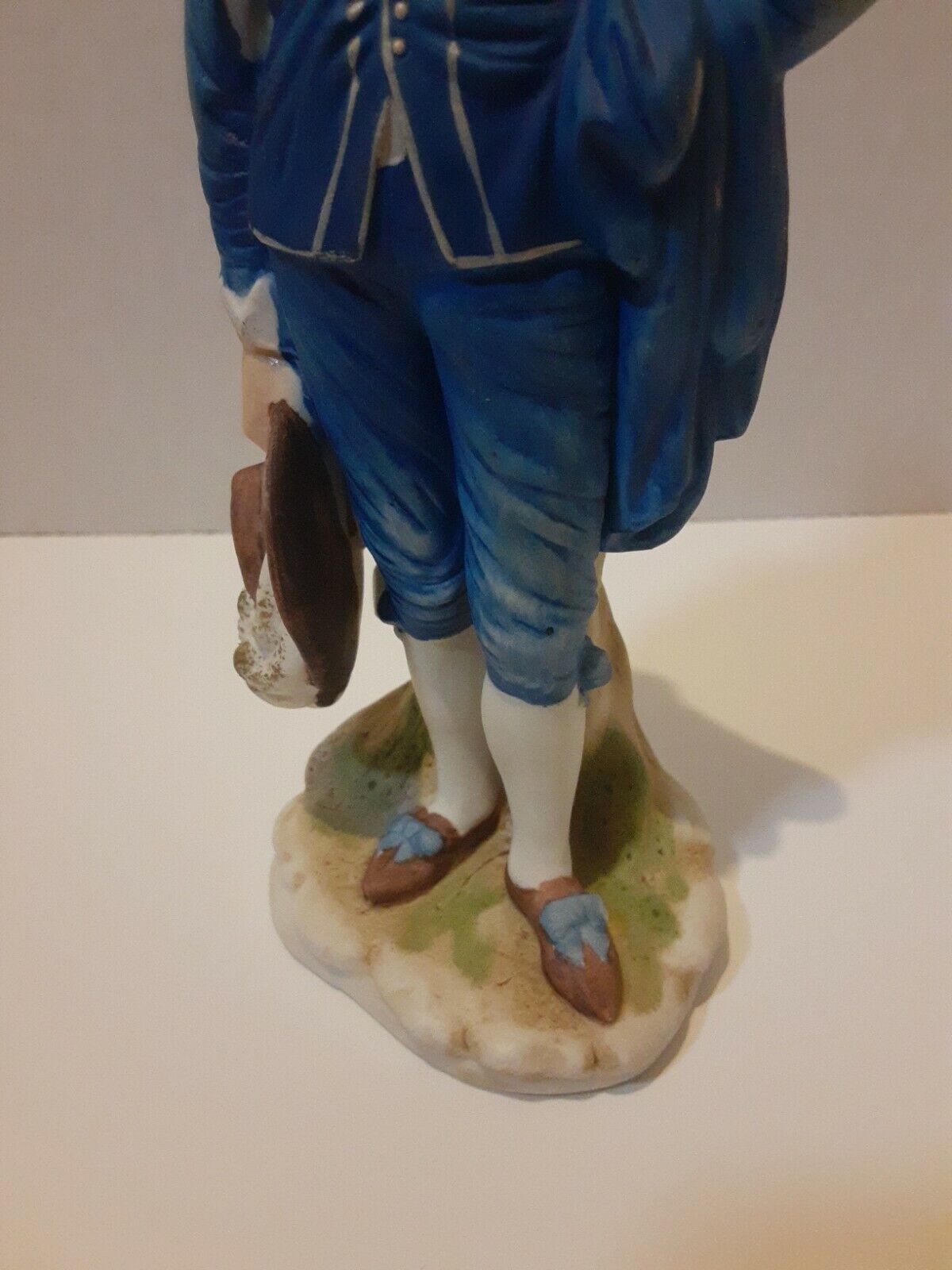 Boy In Blue Suit With Brown Hat In Hand Statue