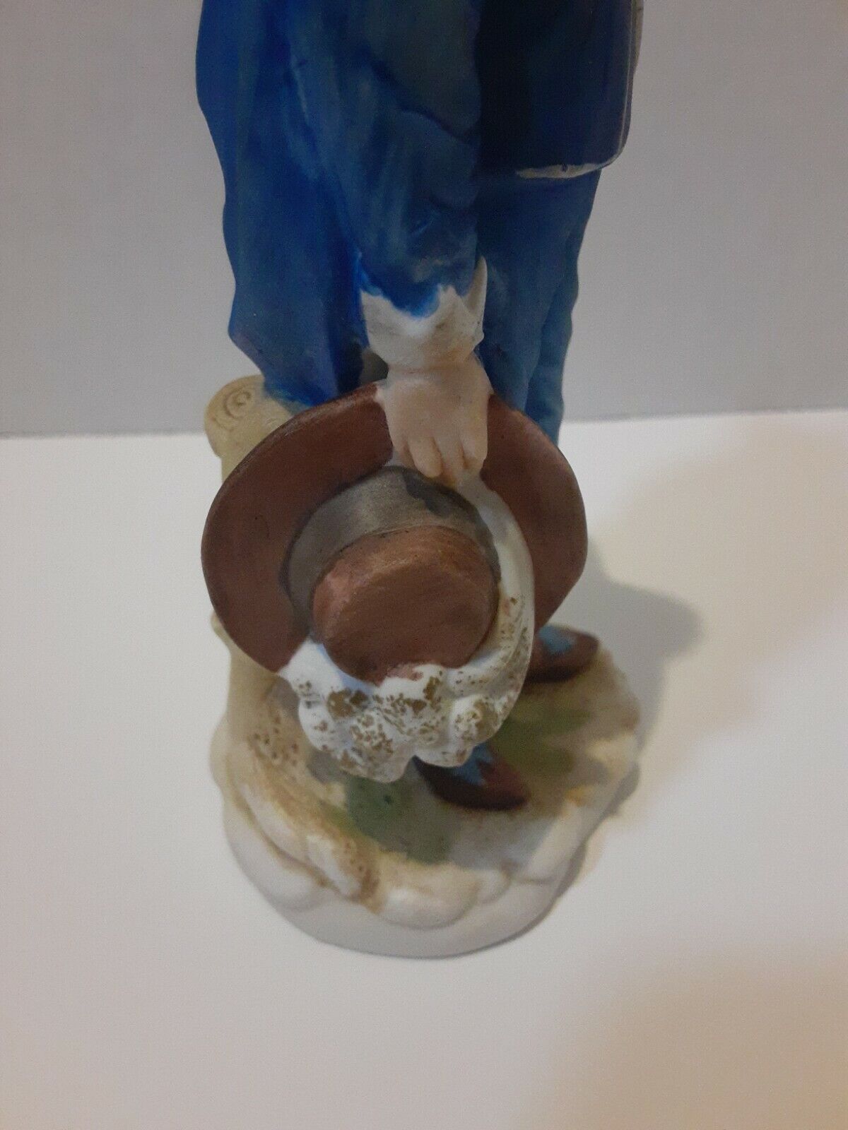 Boy In Blue Suit With Brown Hat In Hand Statue