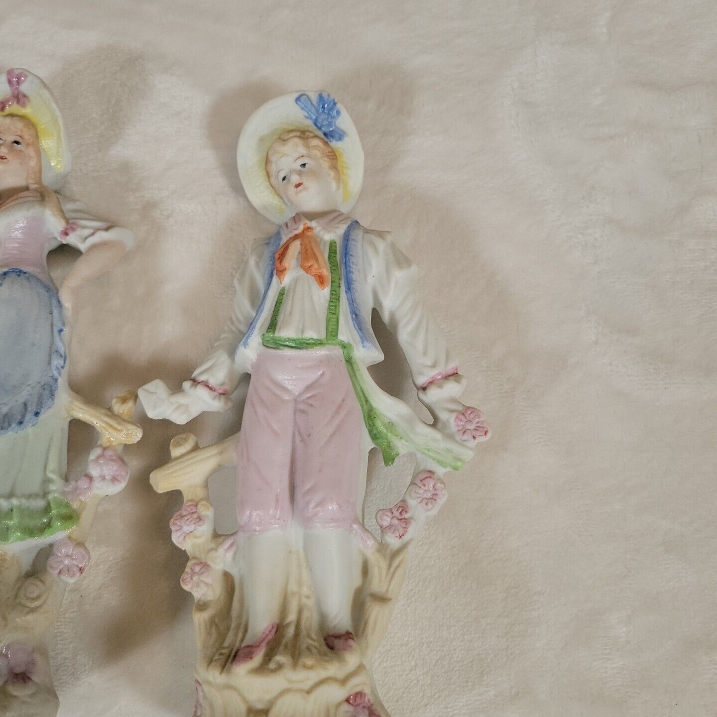 2 Japanese Porcelain Statues of 17th Century Man &  Woman Resting on Fence