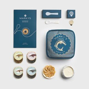 MARKY'S Curated Caviar Tasting Gift Set - 0.5 oz / 14 g (Pack of 4) x Kaluga Royal Amber Caviar, Hackleback Caviar, Siberian Sturgeon Caviar, White Sturgeon Caviar - Caviar Blini - Caviar Serving Set - Spoon, Plate & Tin Opener - Comes with Cooler Gift Bag