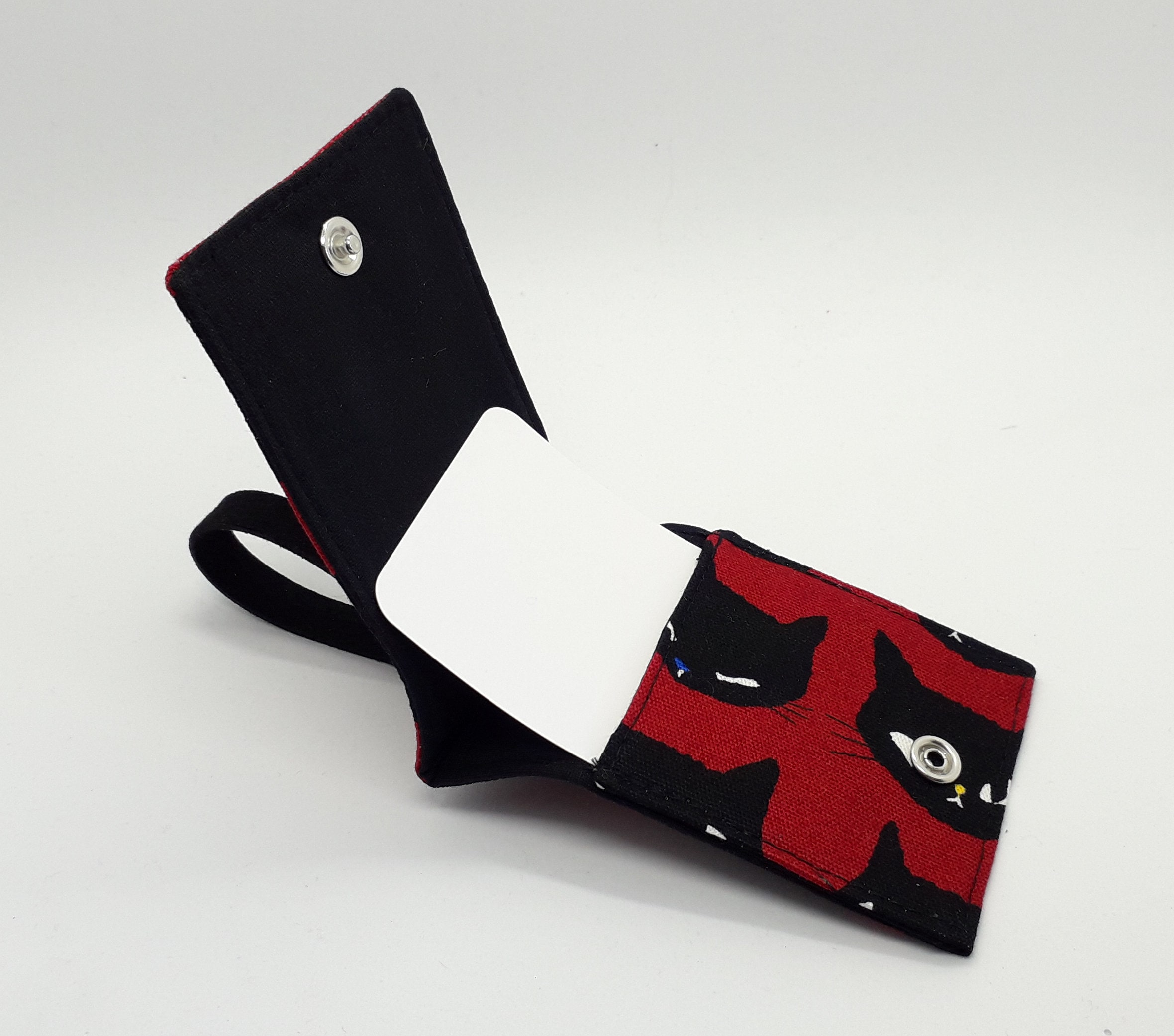 Cat-themed travel essentials in red & black