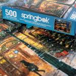 Springbok's Winter Wonderland Cafe 500 Piece Jigsaw Puzzle is a Picturesque Holiday Scene of a Cosy Cafe in The City