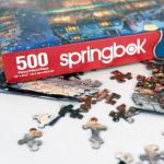 Springbok's Winter Wonderland Cafe 500 Piece Jigsaw Puzzle is a Picturesque Holiday Scene of a Cosy Cafe in The City