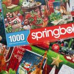 Springbok's Christmas Boutique 1000 Piece Jigsaw Puzzleby Artist Gina Jane Features a Cozy Holiday Boutique Overflowing with Festive Gifts