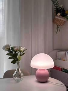 A pink/orange/red/white/beige USB socket decorative table lamp for room light decorative lamp, night light, desk light.