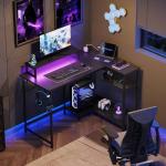 DEVAISE L Shaped Gaming Desk with Power Outlets & RGB LED Lights, 111CM Gaming Desk with Monitor Stand & Hook, Corner Desks with Storage Shelf for Home Office & Small Spaces, Black