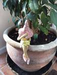 Shy fairy, fairy garden pottery fairy figurine, pixie plant pot ornament, holding a posy of yellow flowers.