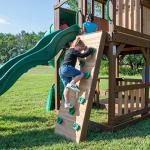 Backyard Discovery Skyfort All Cedar Swing Set, Elevated Covered Wood Roof Clubhouse with Bay Windows, 2 Belt Swings, Web Swing, 10ft Wave Slide, 5 ft Tube Slide, Covered Picnic Table, 5 ft Rock Wall from Backyard Discovery