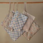 mushie Water Resistant Wet Bags | Large & Small Reusable Storage Bag for Baby Items and Travel | Zippered Pockets with Handle | Machine Washable, Set of 2 (Pastel Blooms)