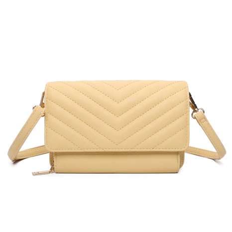 Small white designer handbag with three compartments and flap