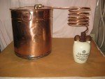 Antique Copper Moonshine Still with Glenmore Whiskey Jug