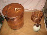 Antique Copper Moonshine Still with Glenmore Whiskey Jug