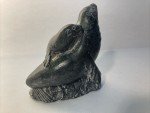 Hand-Carved Soapstone Wolf Sculpture on Rock