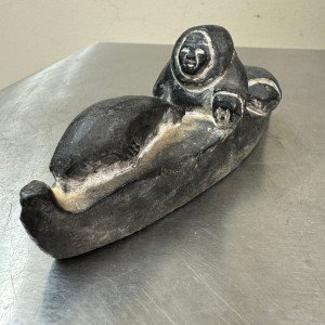 Inuit Stone Carving: Man in Canoe with Seal