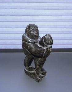 Inuit Soapstone Carving: Man with Seal Sculpture