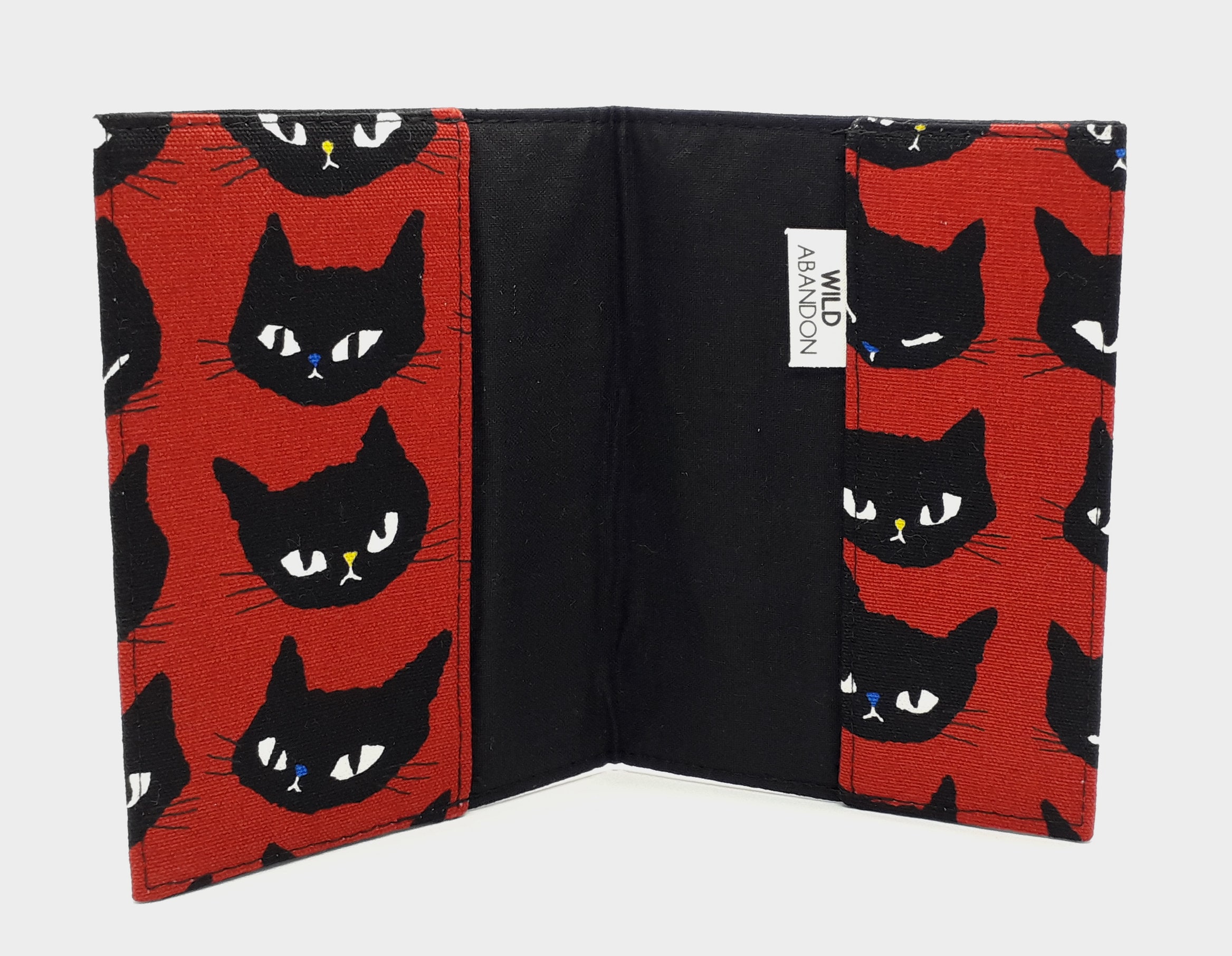 Cat-themed travel essentials in red & black