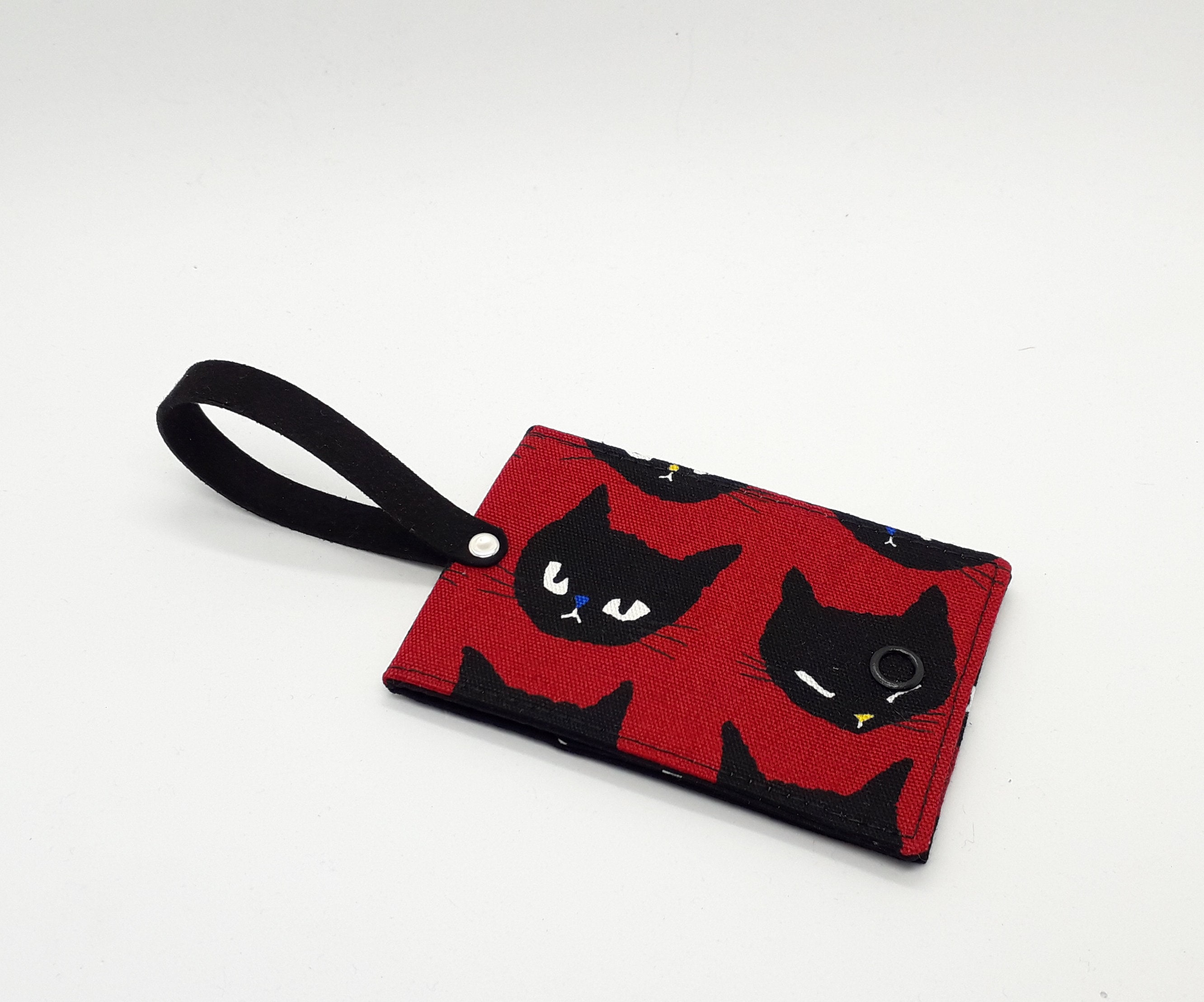 Cat-themed travel essentials in red & black