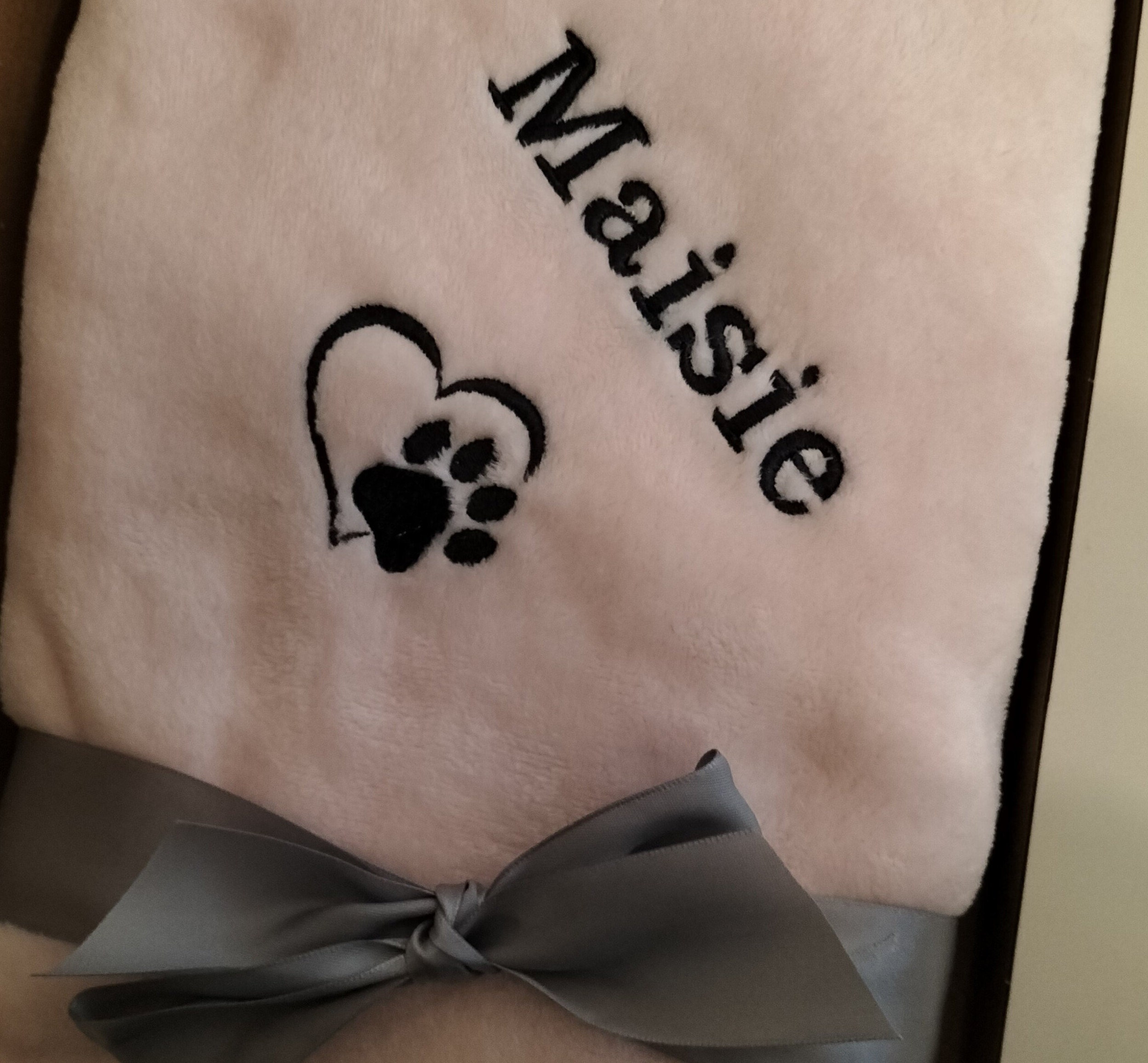 Custom embroidered pet blanket with paw print and name
