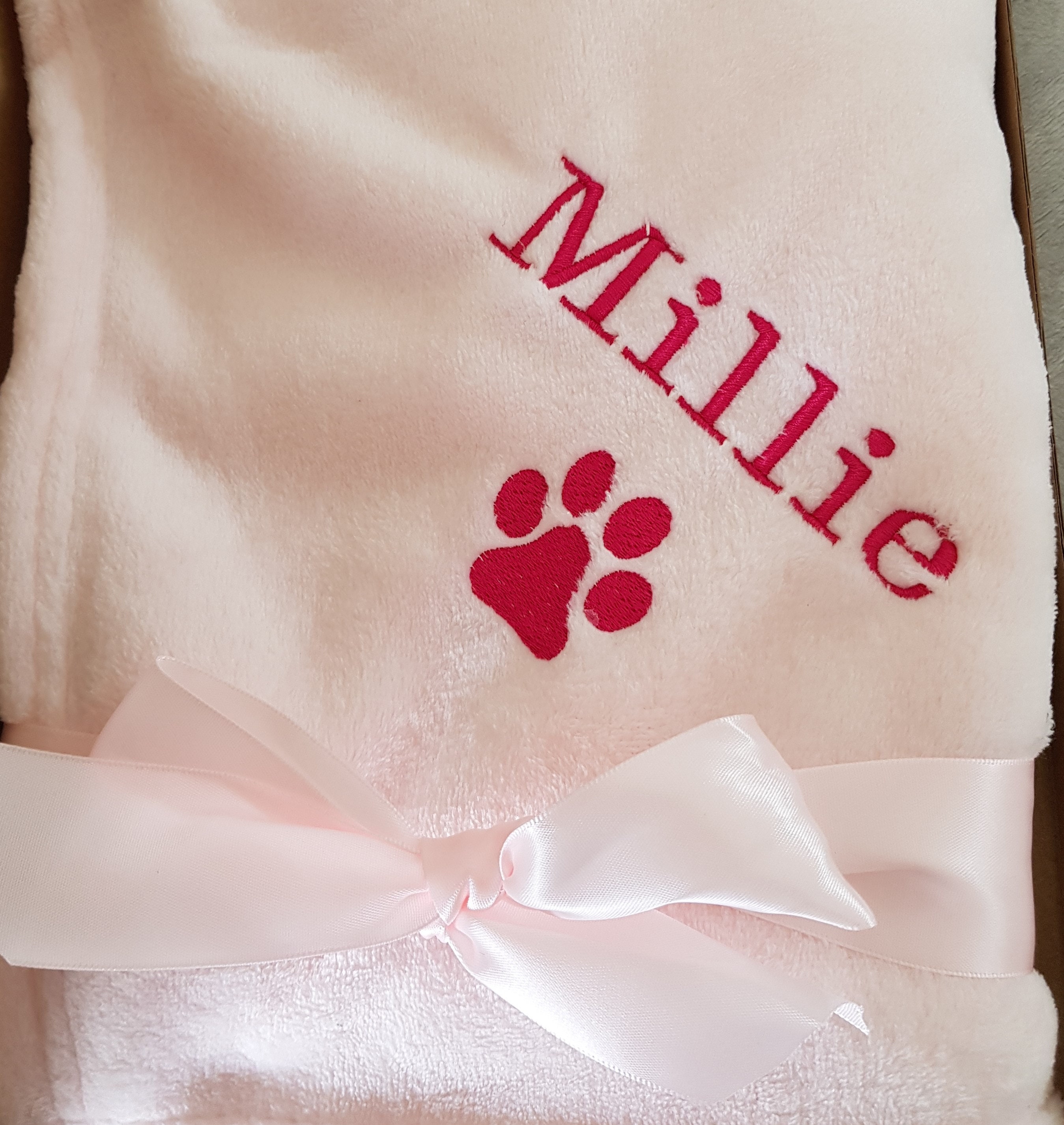Custom embroidered pet blanket with paw print and name