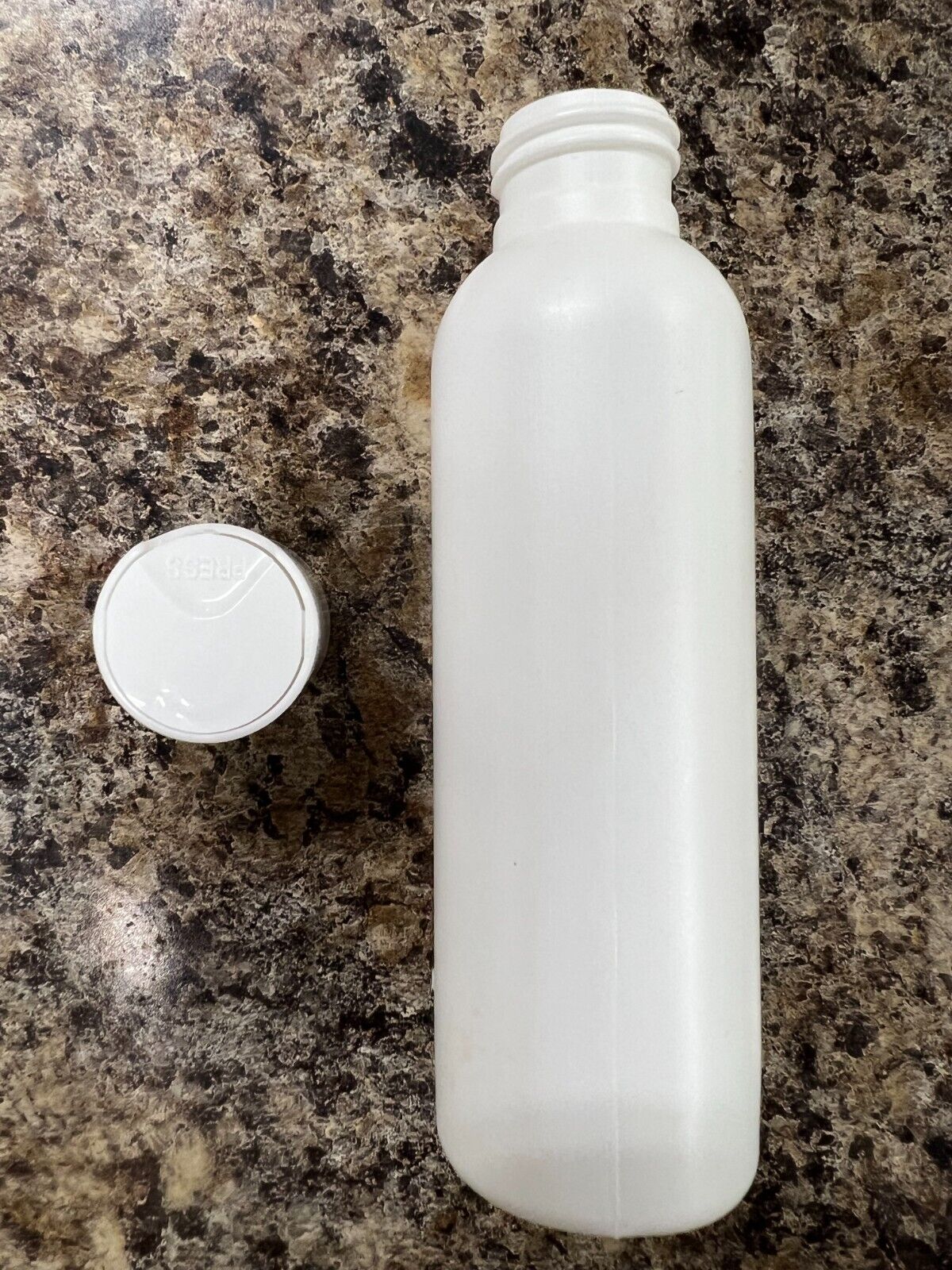 White plastic bullet bottle with disc top cap
