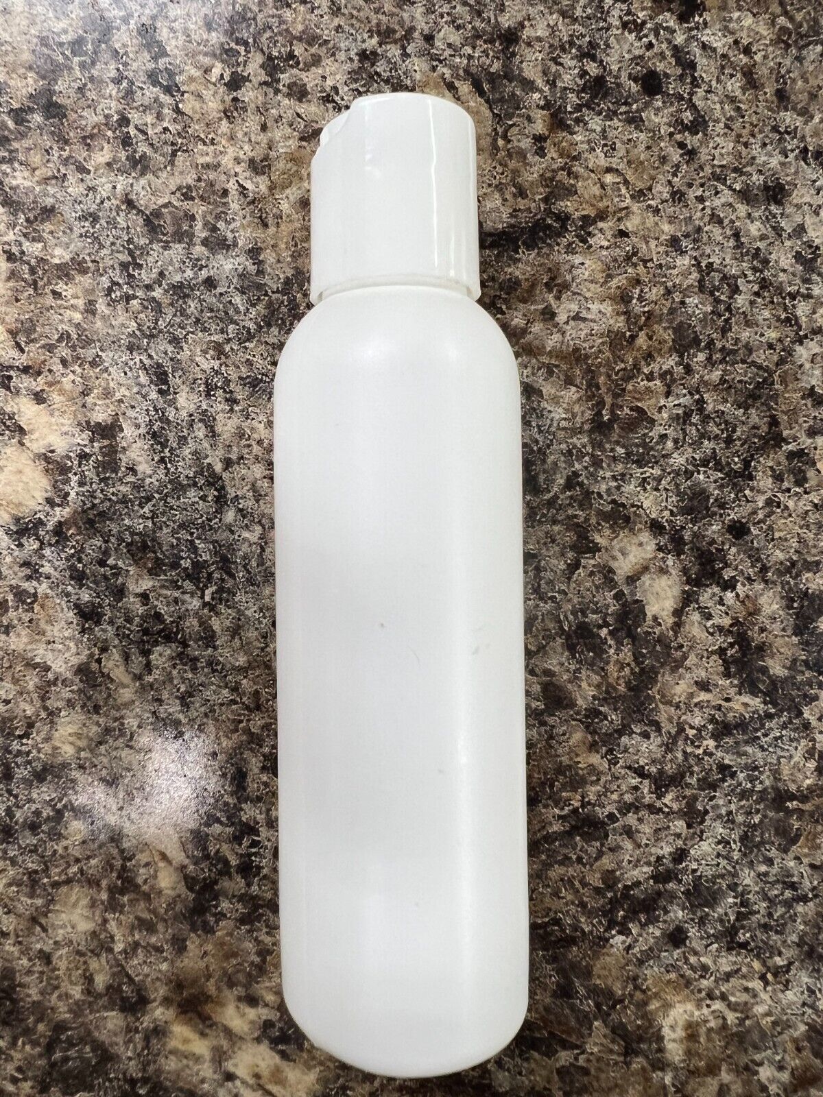 White plastic bullet bottle with disc top cap